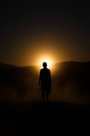 Silhouette of a man in the middle of a foggy landscapeの写真素材