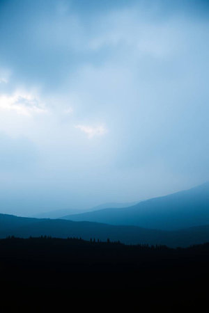 Landscape of mountains and clouds in the blue sky in the eveningの写真素材