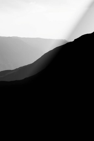 Black and white image of a mountain range in the morning light.の写真素材