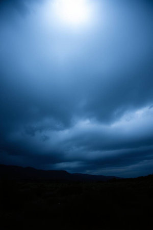 Dramatic stormy sky with dark clouds over mountains in Scotlandの写真素材