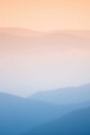 blurred background of mountains and fog in the morning at sunrise.の写真素材