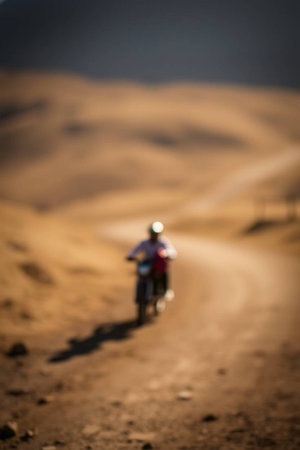 Silhouette of a man riding a motorbike in the desertの写真素材