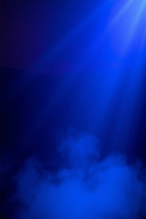 abstract blue background with rays of light and smoke on it.の写真素材