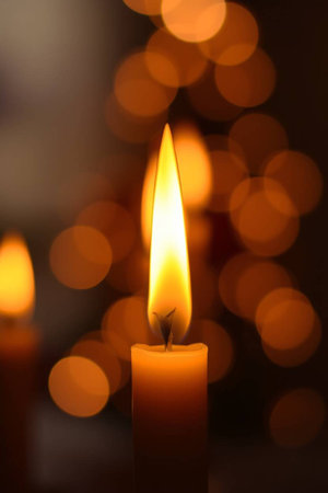 Candle light with bokeh background, close-up.