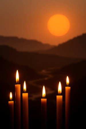 Candles in the shape of a heart on the background of the setting sunの写真素材