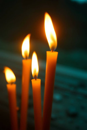 Candles burning in the dark. Close-up. Selective focus.の写真素材
