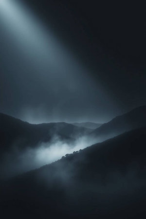 Mysterious foggy landscape in the mountains at night with sunbeamsの写真素材
