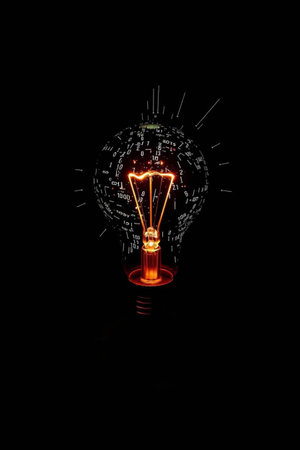 Incandescent light bulb on a black background, idea concept.の写真素材