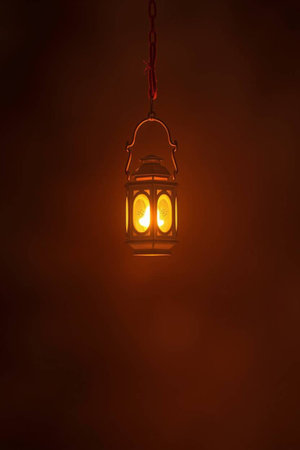 Lantern hanging on a chain with smoke on a dark backgroundの写真素材