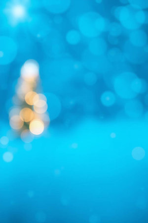 Abstract Christmas background with bokeh defocused lights and snowflakesの写真素材