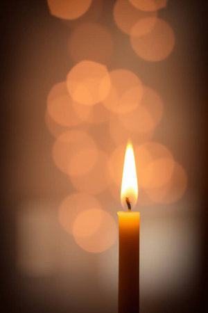 Burning candle with bokeh background, shallow depth of fieldの写真素材