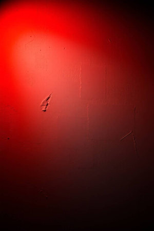 red light on the wall, can be used as background or textureの写真素材