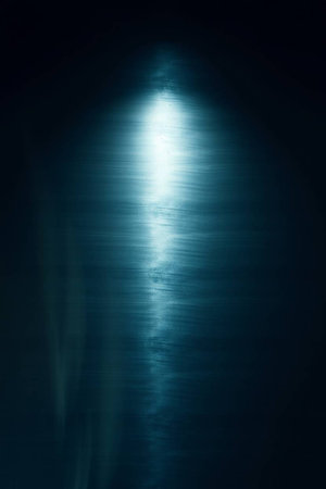 Blue light in the dark, abstract background, long exposure photo.の写真素材