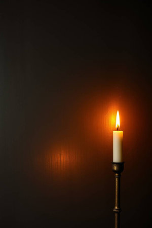 candle on a black background with space for text, close up