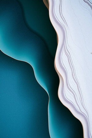 abstract background with white and turquoise waves on blue paperの写真素材