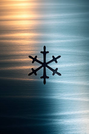 Snowflake on a blue background with a reflection of the sun.