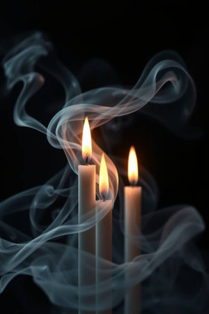 Burning candles with smoke on dark background. Shallow DOFの写真素材