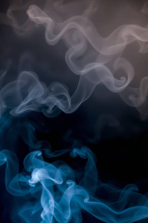 Abstract background of blue smoke on black background. Selective focus.