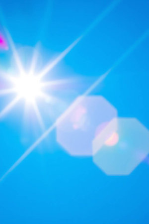 abstract background of sun and blue sky with lens flare effect.の写真素材
