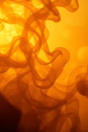 abstract background of orange smoke on a yellow background close-upの写真素材