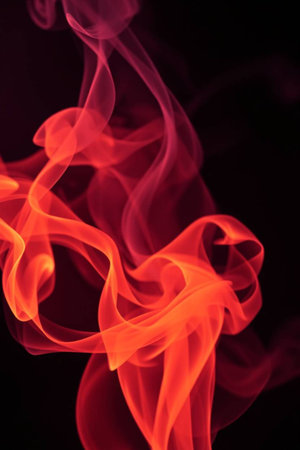 Red smoke on black background. Abstract background. Texture. Design element.