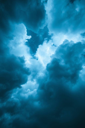 Dramatic dark stormy sky with glowing clouds. Abstract background.の写真素材