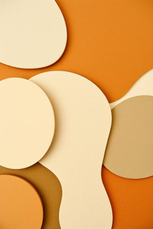 Abstract background made of paper cut shapes in beige and brown colorsの写真素材