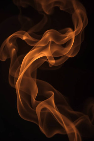 abstract orange smoke on black background, close up, vertical picture
