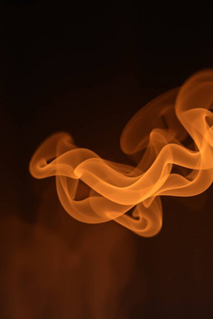 Abstract orange smoke on a black background. Shallow depth of field.