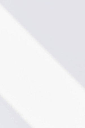 White wall with shadow. Abstract background for design. Copy space.の素材