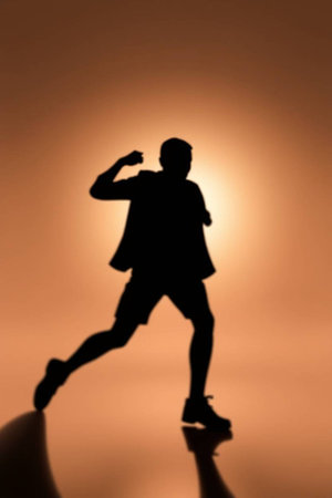 Silhouette of a man running on a light background. Shallow depth of field.の素材