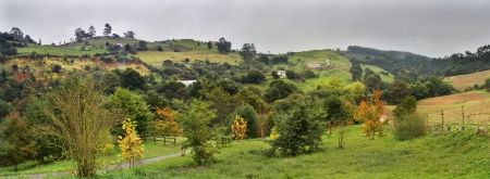 Dark stormy clouds over a green valley in Cantabria Spainの写真素材