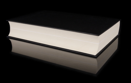 Book with reflection over black isolated backgroundの写真素材