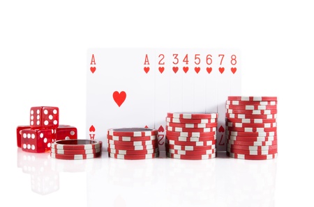 Group of poker cards, poker chips, and red dice over white isolated backgroundの写真素材