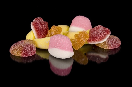 Colorful Candy assortment over black isolated backgroundの写真素材