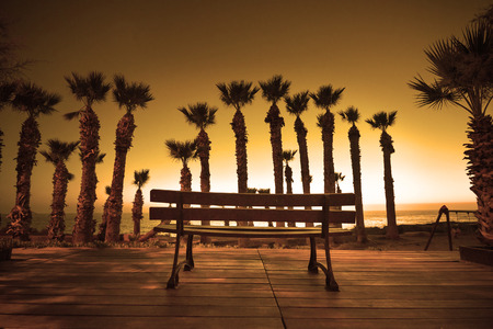 Shilouette of park bench at sunset