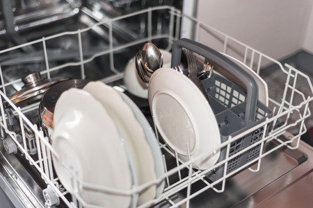 Open dishwasher with clean glass and dishes, selective focusの写真素材