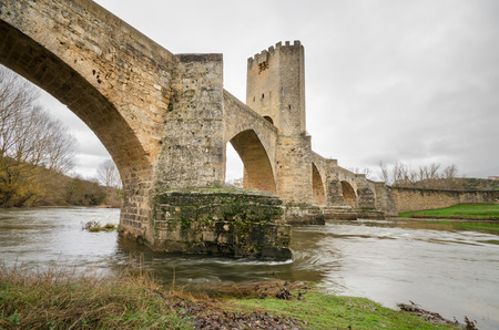 Scenic view of an ancient stone medieval bridge on a cloudy day in Frias, Castilla y Leon, Spain.の写真素材