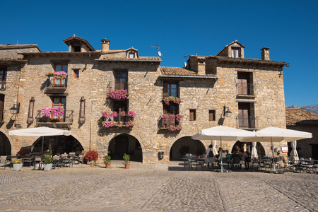 Ainsa, Spain - October 9, 2017: Tourist visiting main square of Ainsa. Is a medieval village of stone houses in Aragonese pyrenees, Huesca, Span.のeditorial素材