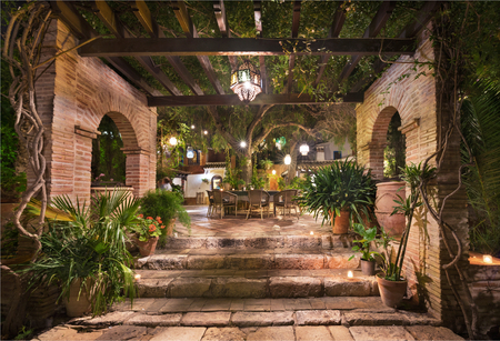 Scenic landscape of an arabic garden at night illuminated with candles and lapms.の写真素材