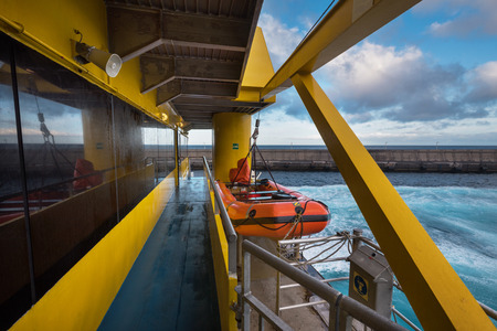 Life boat hanging from the davits of a Ferry.