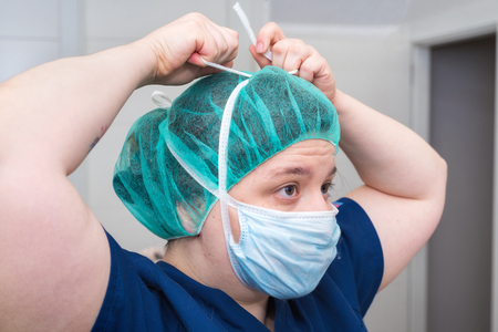 portrait of nurse with mask in surgery roomの写真素材
