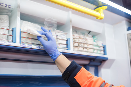 urgency doctor preparing bandage in the ambulanceの写真素材