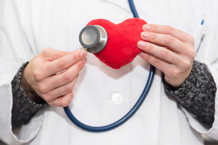 Doctor with stethoscope auscultate heart. Healthy life conceptの写真素材
