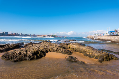 Gijon, Spain - November 19, 2018: Beach of San Lorenzo and tourist walking on a promenade on a sunny dayの写真素材