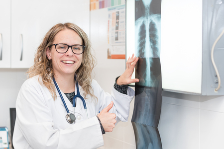 female Doctor examining a radiographyの写真素材