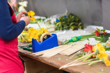 Florist at work. florist creating beautiful bouquet at flower shop. Close up .
