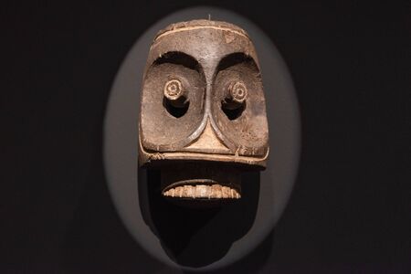 Tenerife, Spain - February 8 2019 : African tribal wooden hand carved mask at African tribal culture exhibition.のeditorial素材