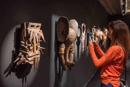 Tenerife Spain - February 8 2019 : Tourist visiting Traditional wooden African tribal masks at...