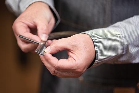 Close up of barber hands changing the razor. Barber hairstyle series.の写真素材